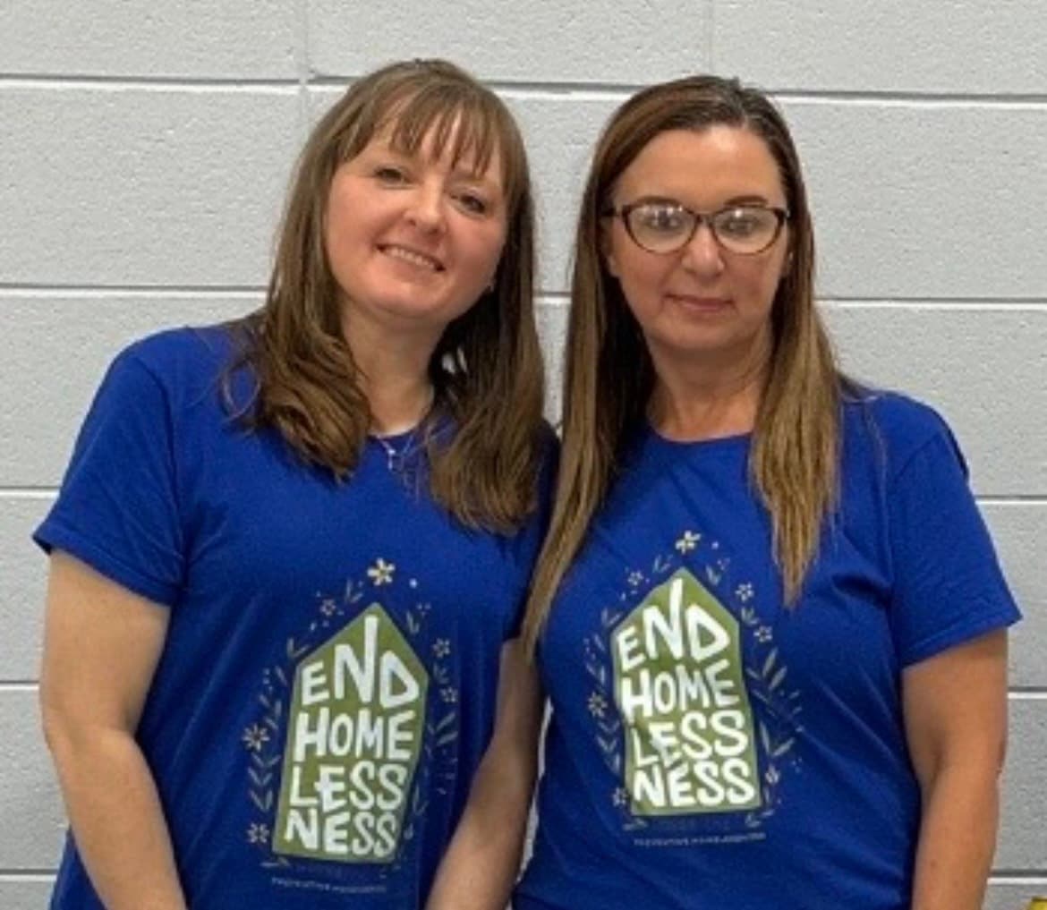 Two Street Outreach team members wearing blue End Homelessness shirts.